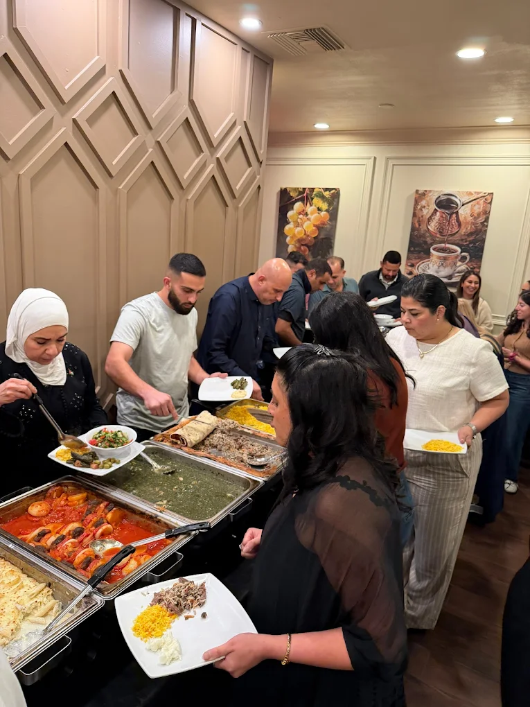 Guests serving themselves from a halal catering buffet by Darna Mediterranean Grill in Tampa